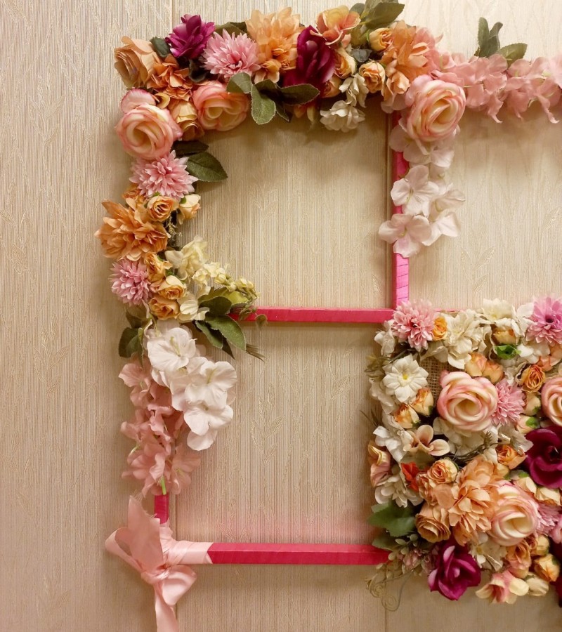 Wall hanging decoration with artificial flowers.