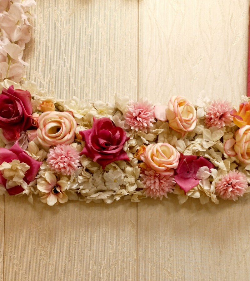 Wall hanging decoration with artificial flowers.